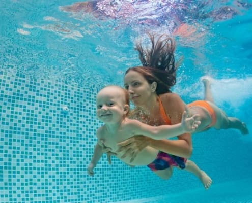 Swimming Pool Safety Homeowner’s Manual Blog Series 2 | Mother and baby swimming in a pool