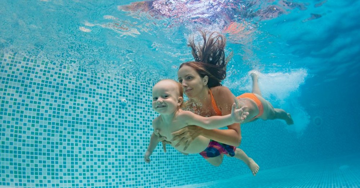 Swimming Pool Safety Homeowner’s Manual Blog Series 2 | Mother and baby swimming in a pool